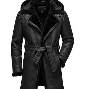 May include: Black leather coat with a hood and a belt. The coat has a faux fur lining and trim around the hood, cuffs, and front opening. The coat has a double-breasted closure with buckles and a tie belt at the waist.