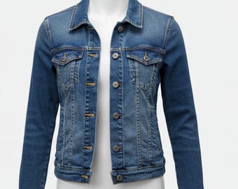 May include: A medium-wash denim jacket with a classic design. The jacket features a button-up front, two chest pockets, and a collared neckline. The jacket is displayed on a white mannequin.