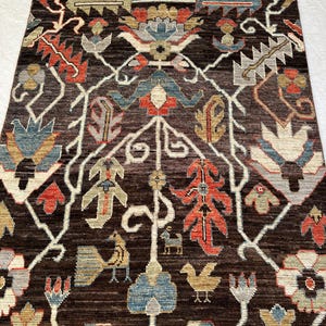 Interior Styling Focus (Best for buyers matching room layouts)
Traditional hand-knotted multi-color Afghan wool carpet from Nazari Turkman Carpet displaying vibrant terracotta orange, soft denim blue, and cream ivory structural graphics, styled flat on a white fabric surface for eclectic living room or dining area inspiration.