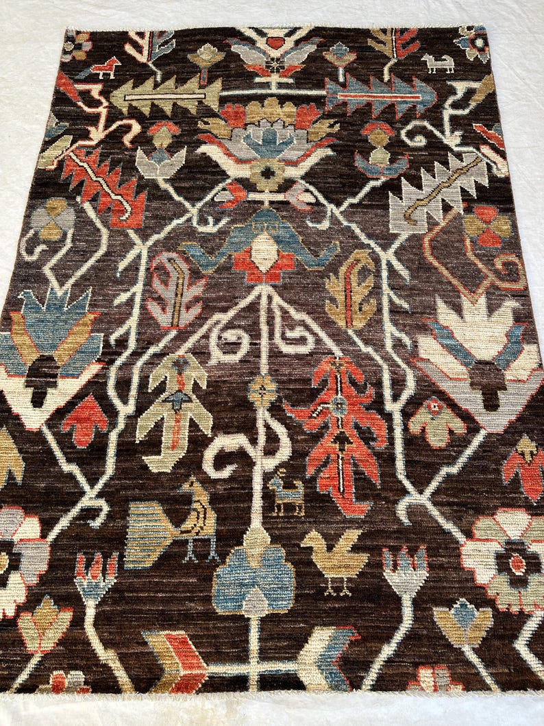 Interior Styling Focus (Best for buyers matching room layouts)
Traditional hand-knotted multi-color Afghan wool carpet from Nazari Turkman Carpet displaying vibrant terracotta orange, soft denim blue, and cream ivory structural graphics, styled flat on a white fabric surface for eclectic living room or dining area inspiration.
