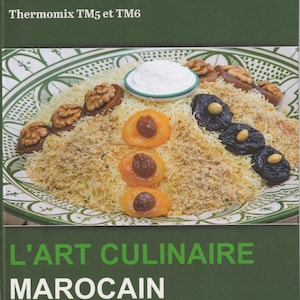 May include: A cookbook titled "L'ART CULINAIRE MAROCAIN" with the text "Thermomix TM5 et TM6" at the top. The cover features a plate of Moroccan food with apricots, prunes, walnuts, and a white sauce. The book has 313 pages.