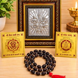 May include: A silver-toned rectangular plaque featuring embossed figures of Lakshmi and Ganesha in a dark ornate frame, flanked by two square gold-toned yantra plates with red and black text, and a dark brown bead mala with a red tassel.
