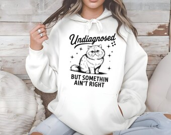 Funny Cat Hoodie: "Undiagnosed But Something Ain't Right" - Unisex Pullover