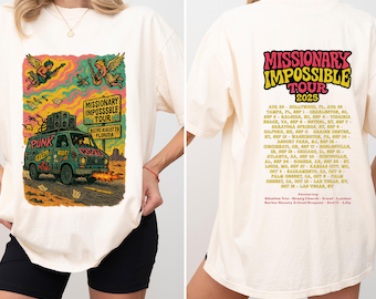 May include: Cream-colored t-shirt featuring a colorful graphic of a van with the text "Missionary Impossble Tour" and "Punk Dear Riot". The back of the shirt lists tour dates for 2025.
