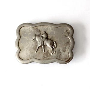 vintage cowboy on horse belt buckle