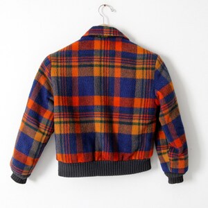 May include: A blue, orange, and green plaid bomber jacket with a ribbed knit collar, cuffs, and waistband.