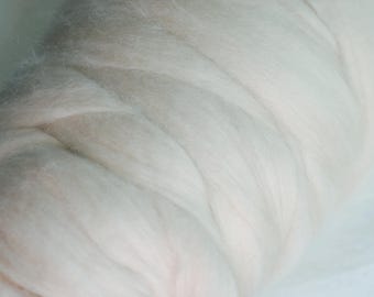 May include: A close-up of a white, fluffy, and soft yarn. The yarn is twisted and piled up, creating a textured and voluminous appearance.