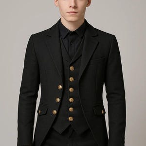 May include: A black suit with a matching vest and shirt. The suit jacket has gold buttons and a tailored fit. The vest also features gold buttons. The outfit is a formal style, suitable for special occasions.
