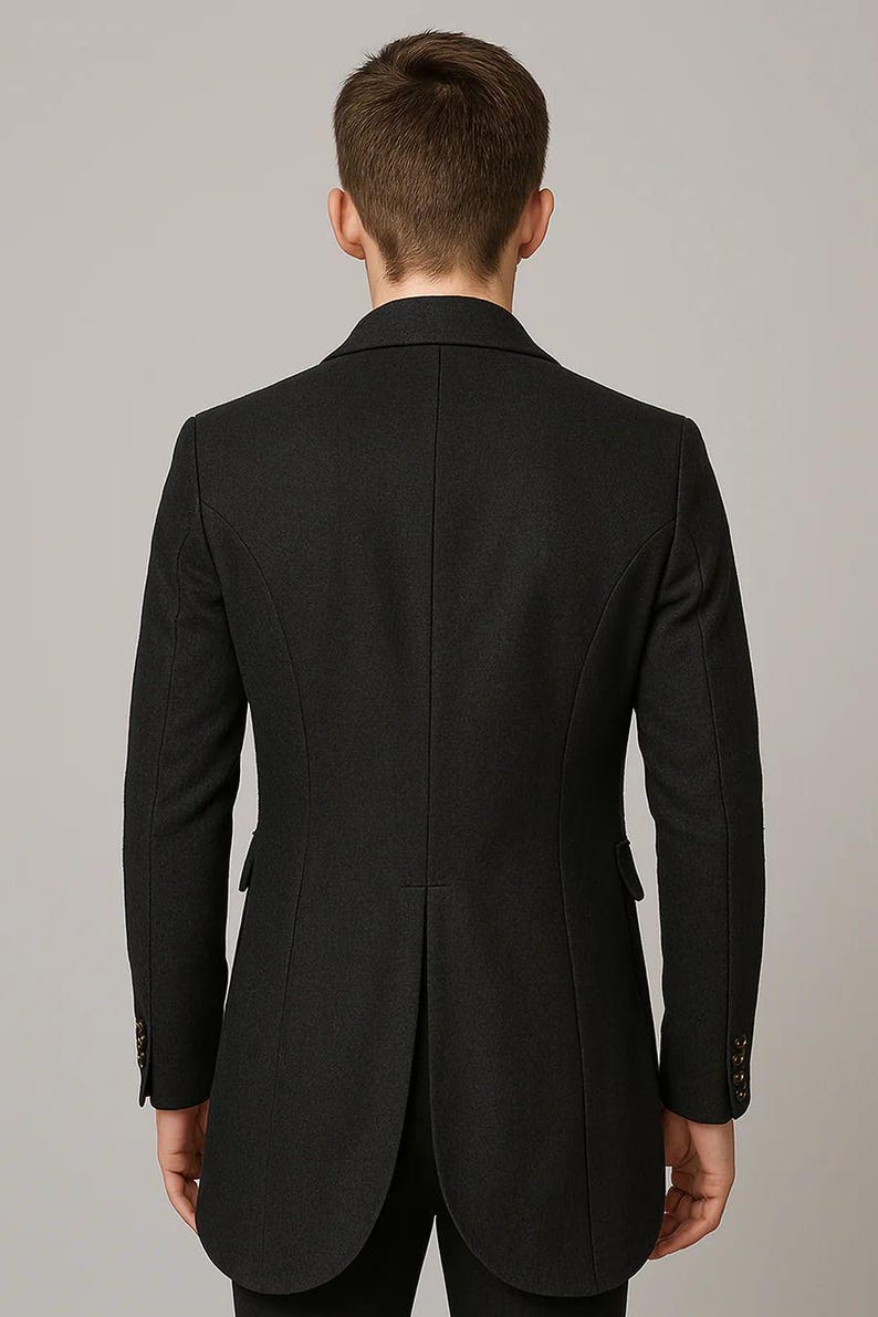 May include: A dark charcoal gray overcoat with a tailored fit. The back view shows a classic design with a notched lapel, two side pockets, and buttoned cuffs. The coat has a single vent in the back and a subtle sheen.