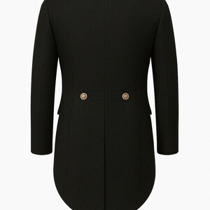 May include: A black tailcoat with a classic design. The coat features a notched collar, long sleeves, and two decorative gold buttons at the back. The coat has a curved hemline and is displayed on a mannequin.