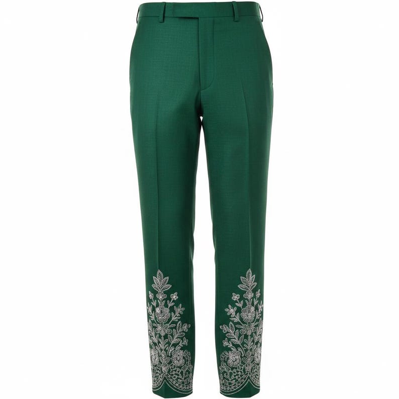 May include: Emerald green tailored trousers with silver floral embroidery on the hem. The trousers have a classic design with a belt loop and button closure. The trousers are approximately 100 cm in length.