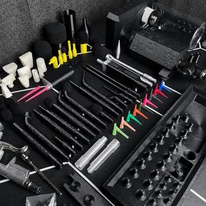 May include: A comprehensive set of black, white, and neon-colored automotive detailing tools, including various nozzles, brushes, a spray gun, a black storage tray with molded compartments, and a white hose, all arranged on a black surface.
