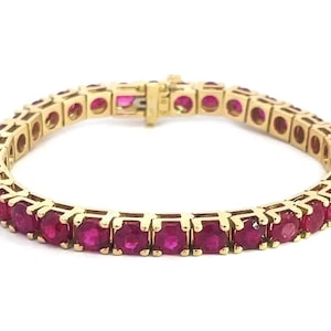 Elegant 14.0CT Ruby Tennis Bracelet Crafted in Luxurious 18K Yellow Gold Showcasing Vivid Red Natural Rubies  This Timeless Piece is Perfect