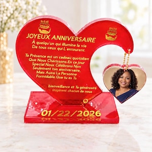 May include: A red heart-shaped acrylic plaque with gold text reading JOYEUX ANNIVERSAIRE and a French birthday message. A smaller heart-shaped photo pendant hangs from the right side. The base displays the date 01/22/2026 in gold lettering.