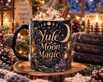 May include: A black ceramic mug featuring the gold text Yule Moon Magic, decorated with celestial moon phases, stars, candles, and crystals. The mug is filled with whipped cream, star-shaped sprinkles, and a cinnamon stick.