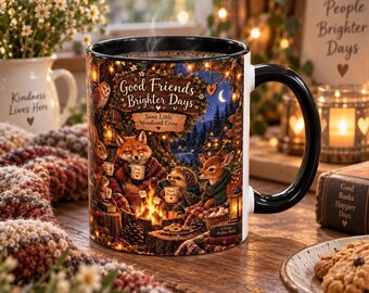 May include: A ceramic mug with a black handle and rim, featuring a colorful illustration of woodland animals around a campfire. The text reads Good Friends Brighter Days, Same Little Woodland Crew, Stay Cozy, Kind People, and A Kinder Brighter World.