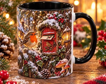 May include: A ceramic mug with a black handle and interior, featuring a winter scene with a robin perched on a snowy tree stump next to a red mailbox, holly berries, pinecones, mushrooms, and a glowing lantern in a snowy forest setting.