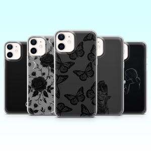 May include: Five phone cases with different designs. The cases display black and white graphics, such as roses, butterflies, and a silhouette. The cases are made of a clear material, allowing the phone's colour to show through.