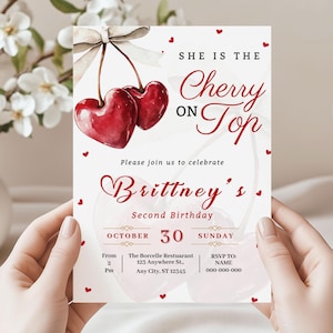 Puede incluir: Una invitación de cumpleaños con un diseño de cerezas en acuarela. El texto dice "She is the Cherry on Top" e invita a los invitados a celebrar el segundo cumpleaños de Brittney el 30 de octubre. La invitación incluye información de RSVP.