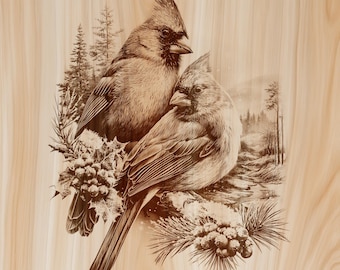 May include: A light-colored wooden panel featuring a detailed sepia-toned laser engraving of two northern cardinal birds perched together. The birds are surrounded by winter elements including pine branches, holly berries, and a snowy forest background.