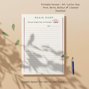 May include: A lined Brain Dump notepad with the text "Brain Dump" and "Dump your thoughts freely. You'll feel lighter." A blue pen and green leaves are next to the notepad. The notepad is A4/Letter size.