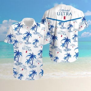 May include: White button-down shirt with a tropical design featuring blue palm trees and the text "Michelob ULTRA". The shirt has short sleeves and a classic collar. The back of the shirt also features the "Michelob ULTRA" logo.