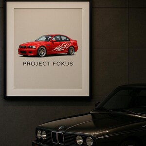 May include: Framed print featuring a red car with white flame decals, labeled "PROJECT FOKUS." The car is a sedan with a sporty design. A black classic car is partially visible in the foreground, adding a vintage contrast.