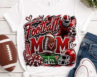 May include: A white short-sleeve t-shirt featuring a graphic print with the text Football MOM in red glitter lettering. The design includes a brown football, a red football helmet, a red foam finger, a red and white pom-pom, and hearts.