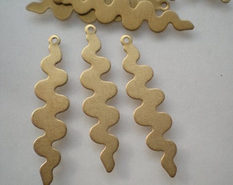 Könnte beinhalten: Drei goldfarbene, wellenförmige Anhänger aus Metall mit einem Loch oben zum Anbringen an Schmuck. Die Anhänger sind etwa 5 cm lang und haben eine gewellte, strukturierte Oberfläche.