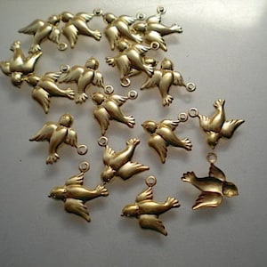 May include: A group of 18 gold-colored metal dove charms. The doves are all facing the same direction and have a slightly raised design. The charms have a loop at the top for attaching to jewelry or other crafts.