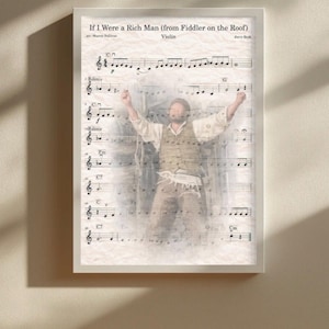 May include: Framed print featuring sheet music for "If I Were a Rich Man" from Fiddler on the Roof, with a superimposed image of a man. The text "Violin" and the composer's name are visible. The print is in a white frame.