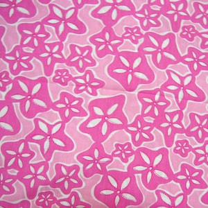 May include: A repeating pattern of stylized, white starfish shapes on a bright pink background. The starfish are outlined in a darker pink, with a lighter pink background. The design is reminiscent of a tropical theme.