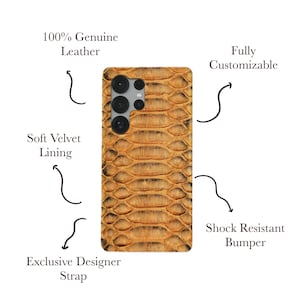 May include: A brown and tan snakeskin-patterned phone case. The case has a camera cutout and is described as 100% genuine leather, with a soft velvet lining, a shock-resistant bumper, and an exclusive designer strap. It is fully customizable.
