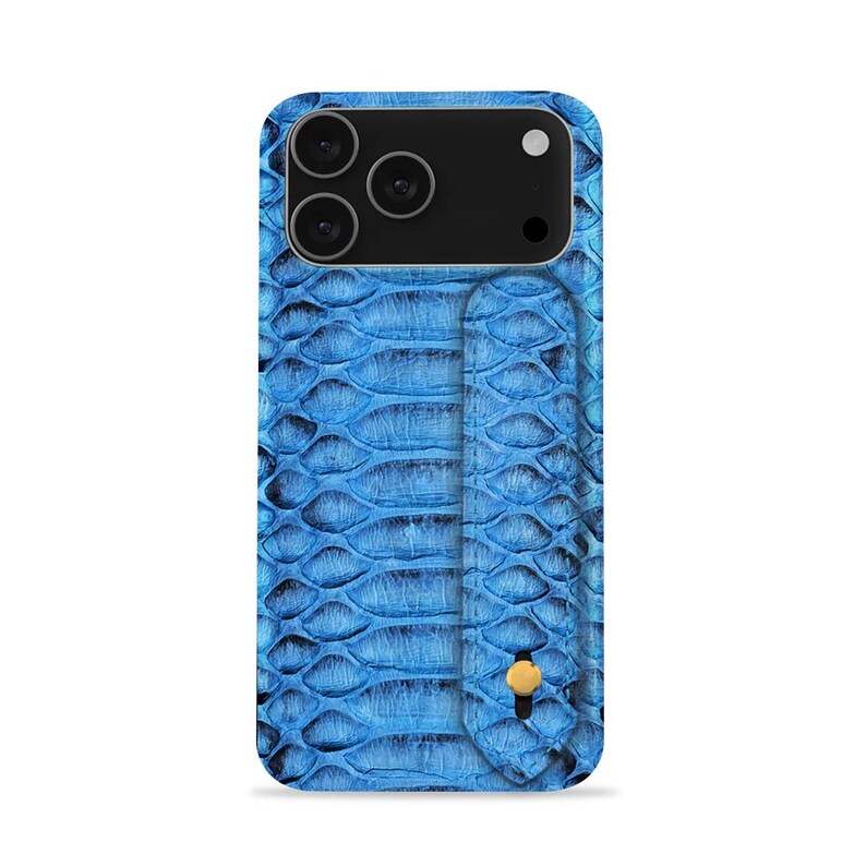 May include: A blue smartphone case featuring a snakeskin texture. The case has a camera cutout for three lenses and a flash. A card holder is attached to the back with a gold-coloured button. The case is designed to fit a smartphone.