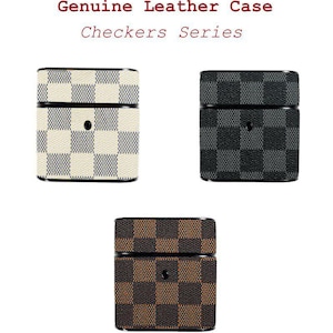 May include: Three leather cases with a chequered pattern. The cases are in cream and beige, black and grey, and brown and tan. The text "Genuine Leather Case Checkers Series" is at the top.