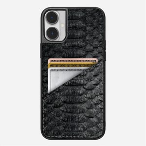 May include: Black textured phone case with a built-in card holder. The case has a snake-skin pattern and a pocket holding three cards. The phone case is designed to fit a smartphone with a dual-lens camera.