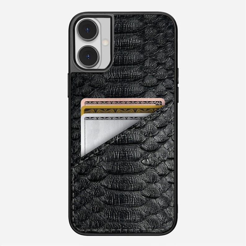 May include: Black textured phone case with a built-in card holder. The case has a snake-skin pattern and a pocket holding three cards. The phone case is designed to fit a smartphone with a dual-lens camera.