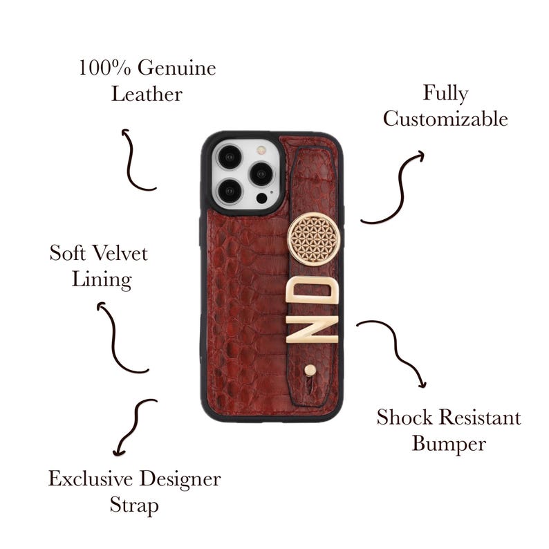 May include: A brown leather phone case with a strap, featuring the letters "ND" in gold. The case has a shock-resistant bumper and soft velvet lining. The text on the case reads "100% Genuine Leather" and "Fully Customizable".