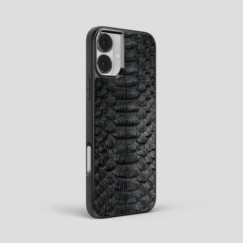 May include: A white ceramic mug with a black handle and the text "But First, Coffee" in a bold, black font. The mug is set against a blurred background, suggesting a cosy setting.