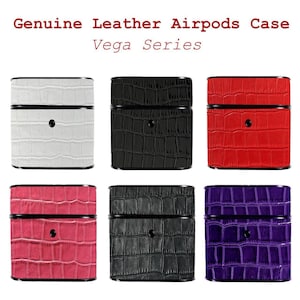 May include: A selection of Genuine Leather Airpods cases from the Vega Series. The image shows six cases in white, black, red, pink, dark grey, and purple. Each case features a textured, crocodile-style pattern and a black top and bottom.