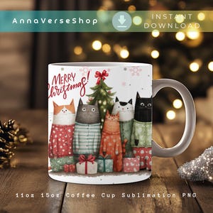 May include: A white ceramic coffee mug featuring a festive design with six cartoon cats wearing pajamas and sweaters, standing in front of a Christmas tree. The mug has the words "Merry Christmas!" and snowflakes. The mug is 11oz.