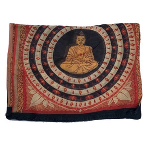 May include: A black, red, and white fabric square with a circular design featuring a golden Buddha figure in the center. The Buddha is sitting in a meditative pose with his hands in his lap. The design is surrounded by concentric circles of red, white, and black.