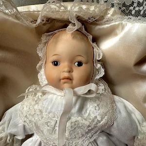 Vintage Ceramic And Cloth Baby Doll In Bascet