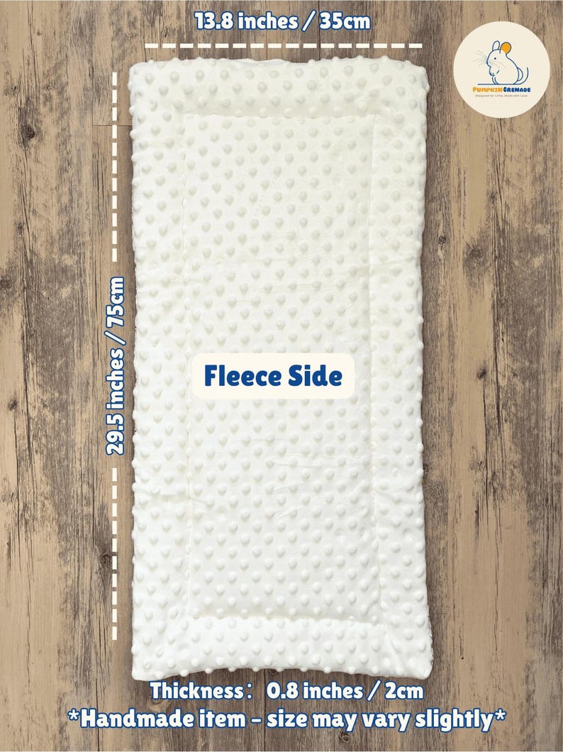 May include: A white fleece baby blanket, 29.5 inches long and 13.8 inches wide, with a textured surface. The blanket has a thickness of 0.8 inches. The text "Fleece Side" is visible. Handmade item.