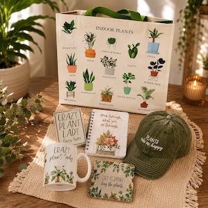 May include: A collection of plant-themed items including a canvas tote bag with indoor plant illustrations, a white mug labeled Crazy plant lady, a spiral notebook, a square sign, a coaster, and an olive green baseball cap with embroidered text.