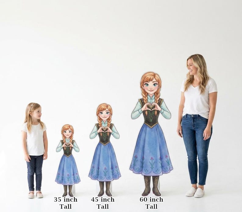 May include: Cardboard cutouts of Anna from Frozen, in three sizes: 35 inches, 45 inches, and 60 inches tall. The cutouts feature Anna in her signature blue dress, with a black bodice and a heart-shaped hand gesture. A young girl and a woman stand nearby.