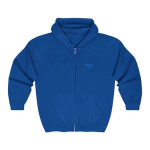 May include: Royal blue zip-up hoodie with a drawstring hood and front pockets. The hoodie features the word "Joja" embroidered on the upper chest. A casual, comfortable garment for everyday wear.