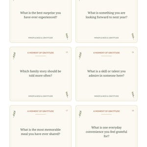May include: Six rectangular off-white conversation cards labeled A MOMENT OF GRATITUDE and MINDFULNESS & GRATITUDE. Each card features a unique numbered question about personal experiences, family stories, skills, meals, and everyday conveniences.