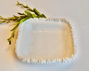 May include: White ceramic square dish with a decorative ruffled edge.