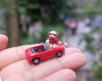 dollhouse miniature baby sock monkey and tiny red car - micro crochet amigurumi animal - 1/2 inch